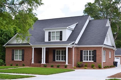 pictures of red brick houses with metal roofs|black shingles on brick house.